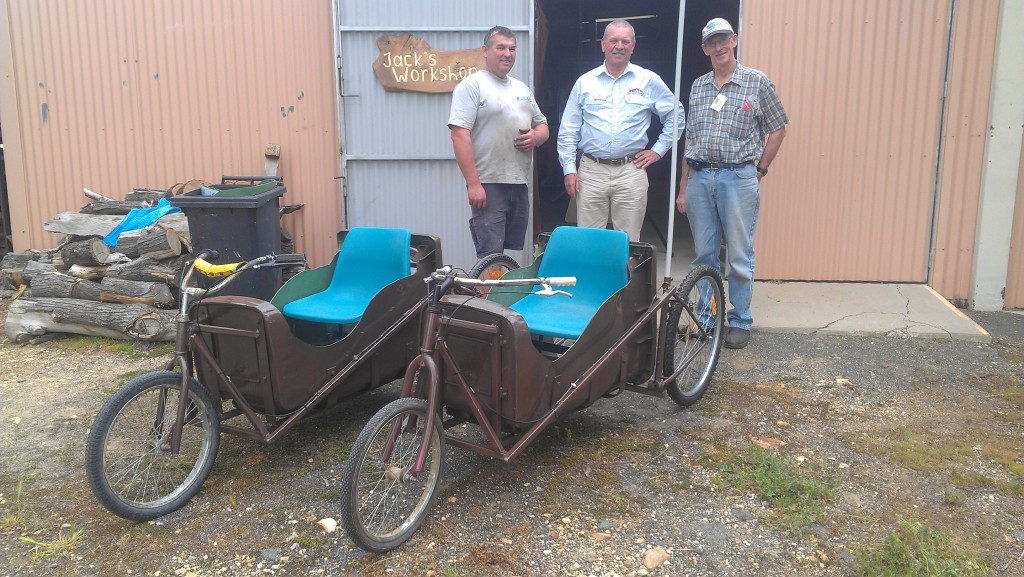 Al Phemister in 2013 handing over two billy carts he designed and built with Roger Holgate for the annual Rotary Billy Cart Derby.  PHOTO: Supplied