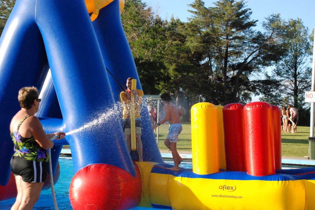 Pool manager Leanne Goode tests out the obstacle course during the 50th birthday celebrations.