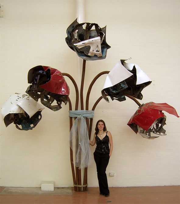 Former Yass artist Melanie Lyons with her piece "Forgotten 2004" made out of used car parts. The council will no longer be purchasing the piece as a public art display on the Barton Highway. PHOTO: YASSarts.org