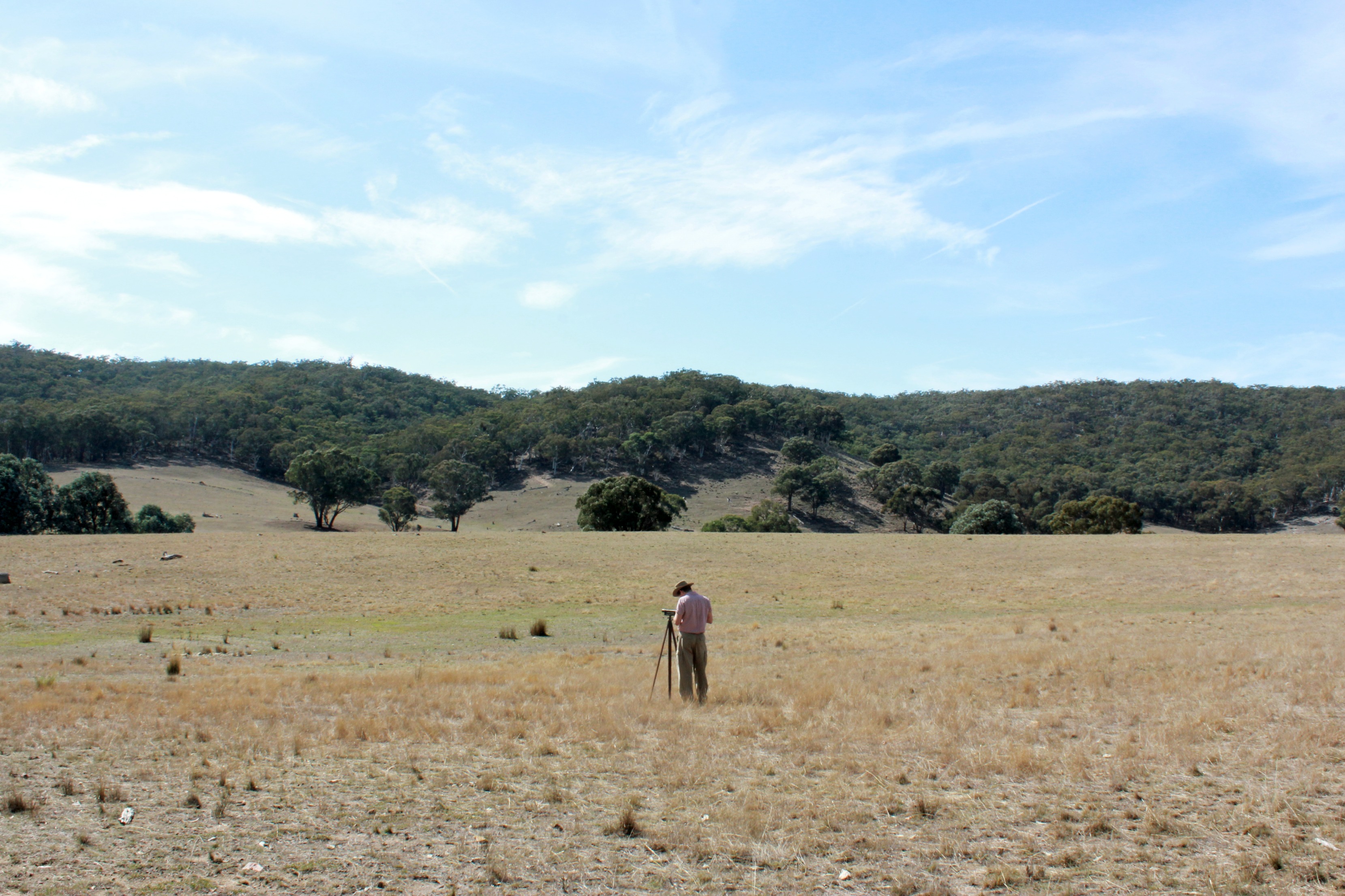 Actor Zackary Drury as The Rival in a field scene.